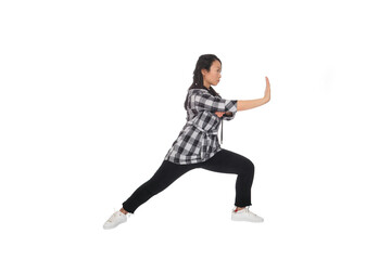 Asian young woman doing martial arts in everyday casual street clothing
