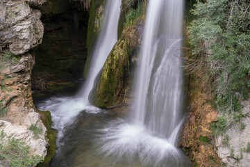 Fototapeta na wymiar Mountain waterfall between rocks in the Alto Tagus. Guadalajara. Spain