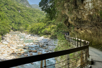 Fototapeta premium Walking path built into side of mountain on Shakadang trail in Taroko Gorge, Taroko National Park, Taiwan