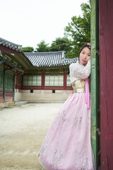 Fototapeta premium Asian woman wearing a pink traditional hanbok dress in Changdeok