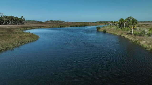 Florida Sawgrass on the ocean in Hernando Beach Florida.  Drone view flyover from above Blue sky sea view wetlands west Florida