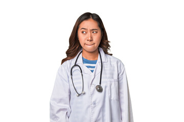 Fototapeta premium A young asian doctor woman confused, feels doubtful and unsure.