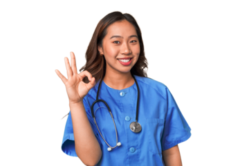 A young nurse chinese woman cheerful and confident showing ok gesture.