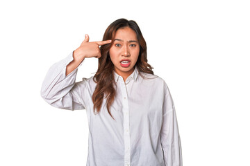 A young chinese woman showing a disappointment gesture with forefinger.