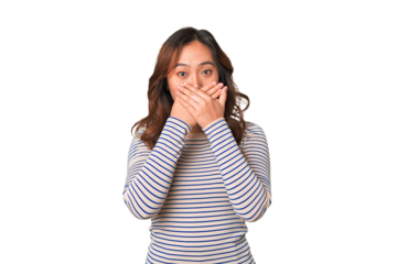 A young chinese woman shocked covering mouth with hands.