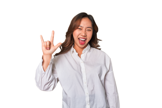 A young chinese woman showing a horns gesture as a revolution concept.