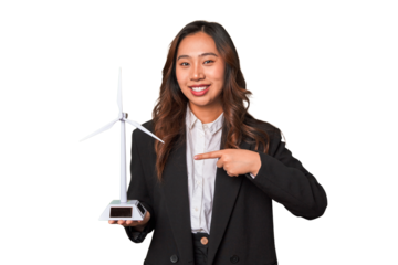 A young Chinese businesswoman proudly holds a windmill, symbolizing her commitment to renewable energy and sustainable development.