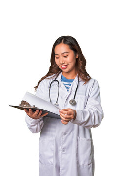 Attentive Chinese woman doctor reading patient report with professional care.