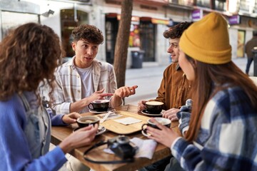A multicultural group of friends enjoying coffee and tea after their vacation.