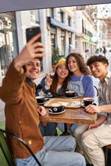 Coffee time with friends from around the world, capturing memories with a selfie