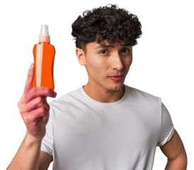 A young man protects his skin from harmful UV rays, applying non-greasy, broad-spectrum sunscreen for a healthy and youthful look.