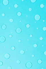 Fototapeta na wymiar Bright pastel blue background with water and rain drops. Creative minimal concept of water and hydration.