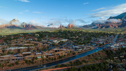 Aerial view of Sedona, Arizona with clouds covering some of the mountains.