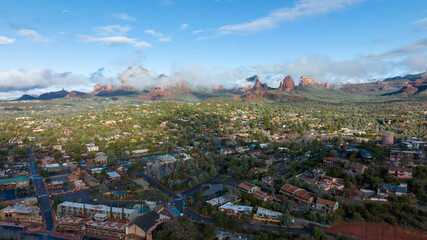 Aerial view of Sedona, Arizona with clouds covering some of the mountains.