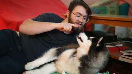 View of man with husky dog. E-date online services, video call using phone or pc, distance chat...