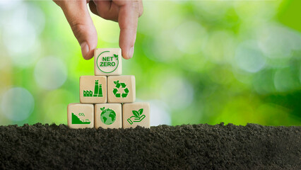 Carbon neutral and target greenhouse gas emissions ,hand holding a wooden block with a green net icon in the middle net zero natural environment concept