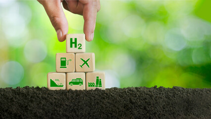 Net zero reduction in greenhouse gas emissions. hand holding wooden block with green background icon clean hydrogen energy concept Environmentally friendly and alternative energy industries