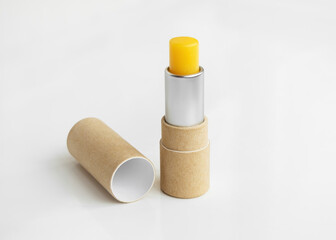 hygienic lip balm in a brown craft tube on a white table