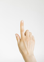 a woman's hand points a finger at an empty white space