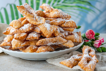 Traditional Italian carnival fritters dusted with icing sugar - frappe or chiacchiere