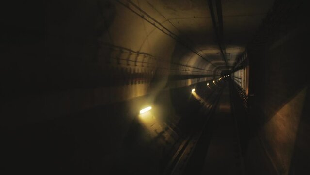 First-person view of the driver of a subway train moving in a tunnel. Concept of underground urban transport