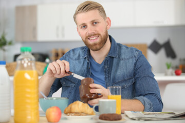 Fototapeta na wymiar handsome young man having breakfast