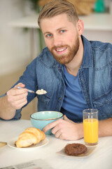 Fototapeta na wymiar portrait of happy young man having healthy breakfast