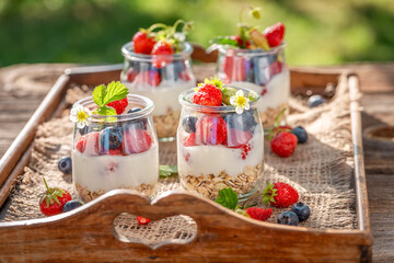 Homemade granola with oat flakes and yoghurt in jar.