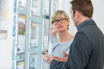 woman inquiring in a real estate agency