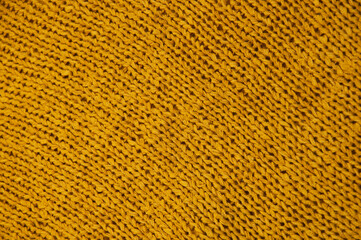 yellow unusual texture.knitted orange sweater close up. handmade concept