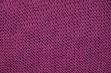 purple unusual texture.knitted pink sweater close up. handmade concept