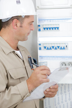 electromechanic checking industrial distribution fuseboard