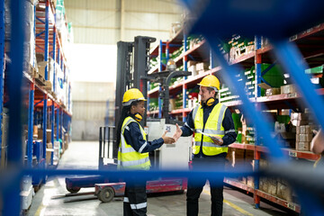Fototapeta premium Warehouse workers checking the inventory. Products on inventory shelves storage. .Worker Doing Inventory in Warehouse. Dispatcher in uniform making inventory in storehouse. supply chain concept