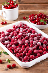 Frozen cherries on a wooden table. Frozen food