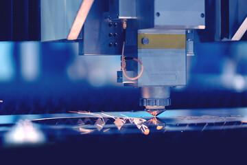 Industrial CNC Laser background with light spark, industry machine factory with blue bokeh