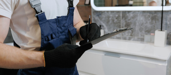 Banner plumber man with paper tablet control work in bathroom, install plumbing fix repair service