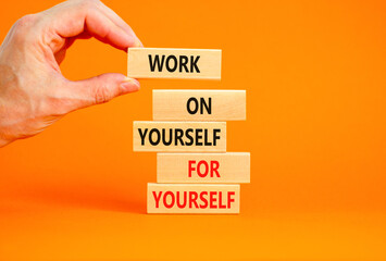 Work for yourself symbol. Concept words Work on yourself for yourself on wooden block. Beautiful orange table orange background. Businessman hand. Business and work for yourself concept. Copy space.