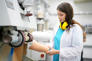Production of a prosthetic leg. A man creates a part of the leg above the knee. Grinds the plastic...