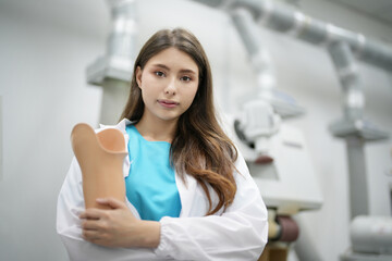 Orthopedic technician adjusting prosthetic leg for disabilities people