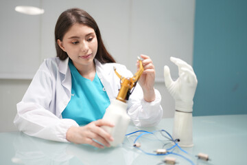 Female physiotherapist and Bionic Hand with artificial intelligence technology.