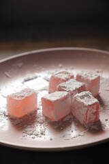 macro shot Turkish delight on a pink plate