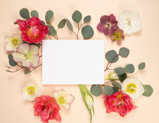 Bridal stationery flat lay with fresh flowers, tulips, hellebores and eucalyptus
