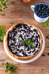 Cottage cheese casserole baked with blueberry. Curd casserole with fresh berries on table. Top view