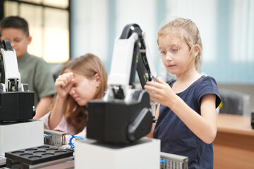 Children learning AI technology Robot with artificial intelligence system on its about the artificial intelligence during science lesson.