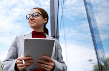 Fototapeta premium Young businesswoman with tablet in city.