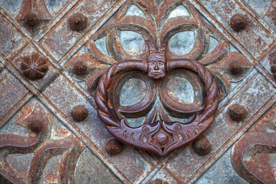 Antique iron handle on an iron door