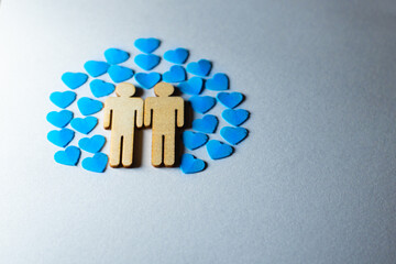 Male love LGBT. Same-sex family icons. gay couple of two homosexual men. The male couple is holding hands. Wooden people with paper blue hearts