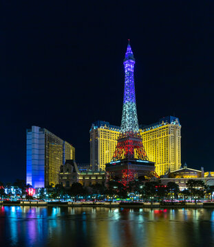 Las Vegas, United States - November 23, 2022: A picture of the Paris Las Vegas at night, with the Eiffel Tower decorated with the colors of the French flag.
