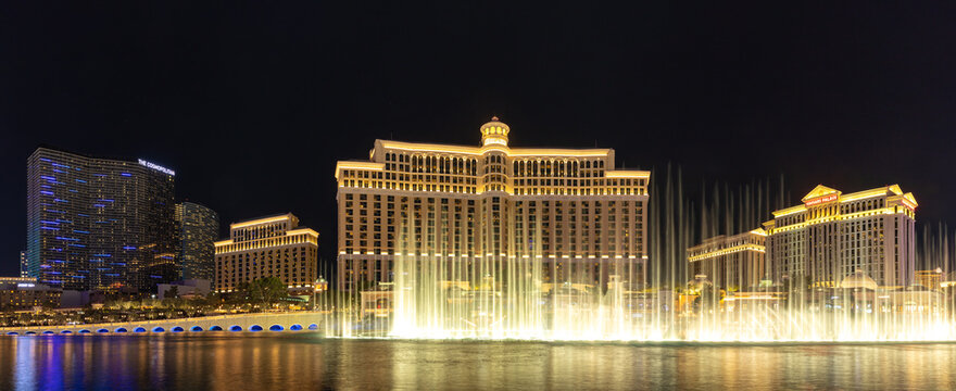 Las Vegas, United States - November 23, 2022: A panorama picture of the Bellagio Fountain Water Show at night.