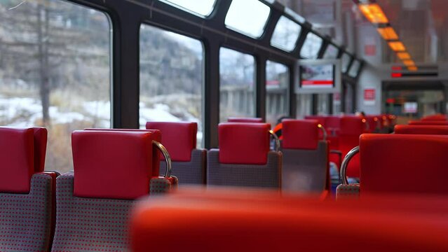 Riding a train on Zermatt Shuttle line in the Swiss Alps arriving to the station. This famous mountain resort town is not accessible by car for ecological reasons. 